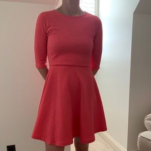 Bright pink long sleeved dress.